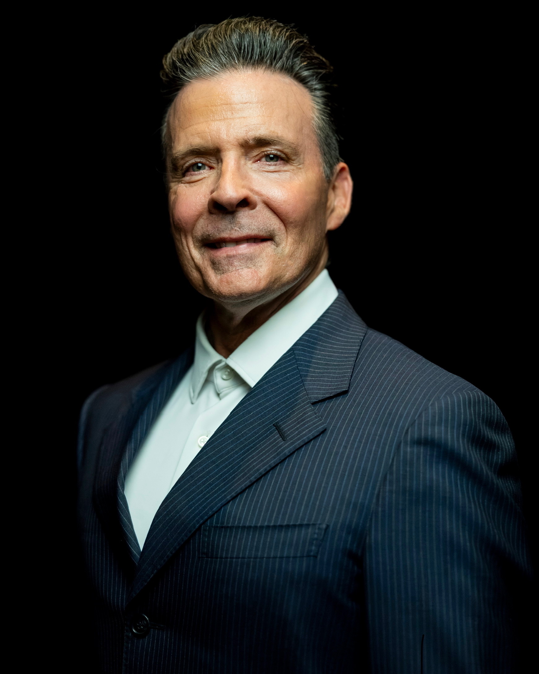 David M. Tetreault in a dark suit against a black background
